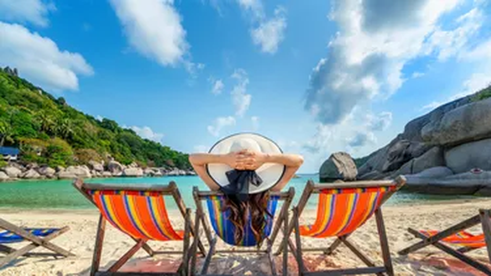 woman-with-hat-sitting-on-chairs-beach-in-beautiful-tropical-beach-woman-relaxing-on-tropical-beach-at-koh-nangyuan-islandjpg