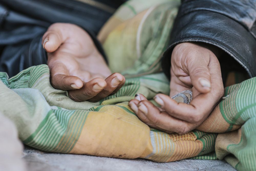 homeless-woman-holding-hands-out-for-help-scaled.jpg